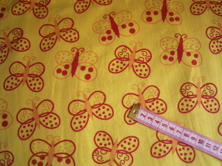 Jerseystoff gelb mit Schmetterlingen in rot orange