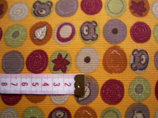 Sweatshirtstoff orange mit verschiedenfarbigen Kreisen und Motiven